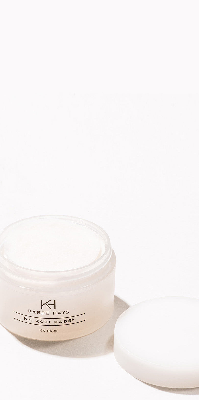 A small translucent cosmetic jar labeled KH Karrie Hays Ki Koji Padsy, shown with its white lid beside it on a clean white background.