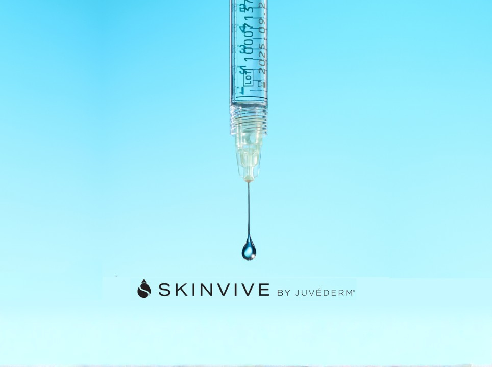 Syringe with a drop of liquid against a blue background, featuring the Skinvive by Juvederm logo.
