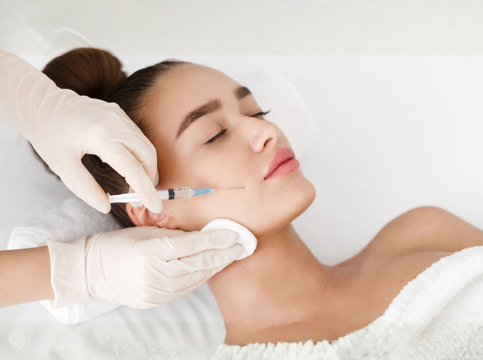 Woman receiving a facial treatment with a needle in a clinical setting.